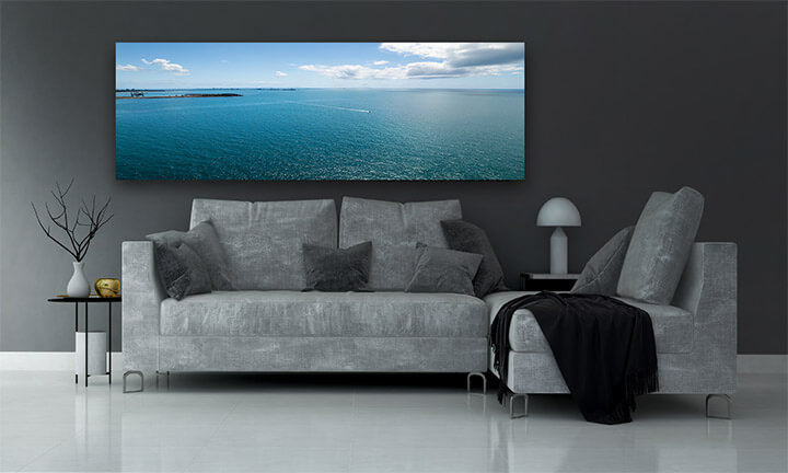 M2 0011 MOCKUPs 0006 39304824 boat speeds across the water from a coal export port towards shore under a cloudy blue AOAY2154